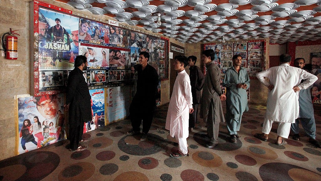 Pakistani cinema-goers look at photos displayed at a local cinema in Karachi, Pakistan, Sunday, 18 December 2016. (Photo: AP)