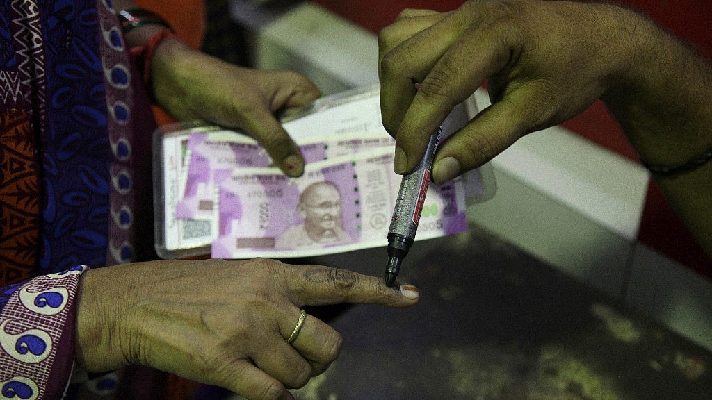 A woman gets an ink stamp after reaching the cash withdrawal limit. (Photo: AP)