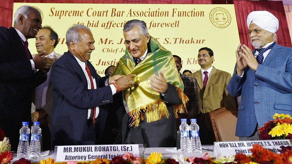 Outgoing Chief Justice of India Justice TS Thakur is presented a shawl as CJI-designate Justice JS Khehar (right) looks on. (Photo: PTI)