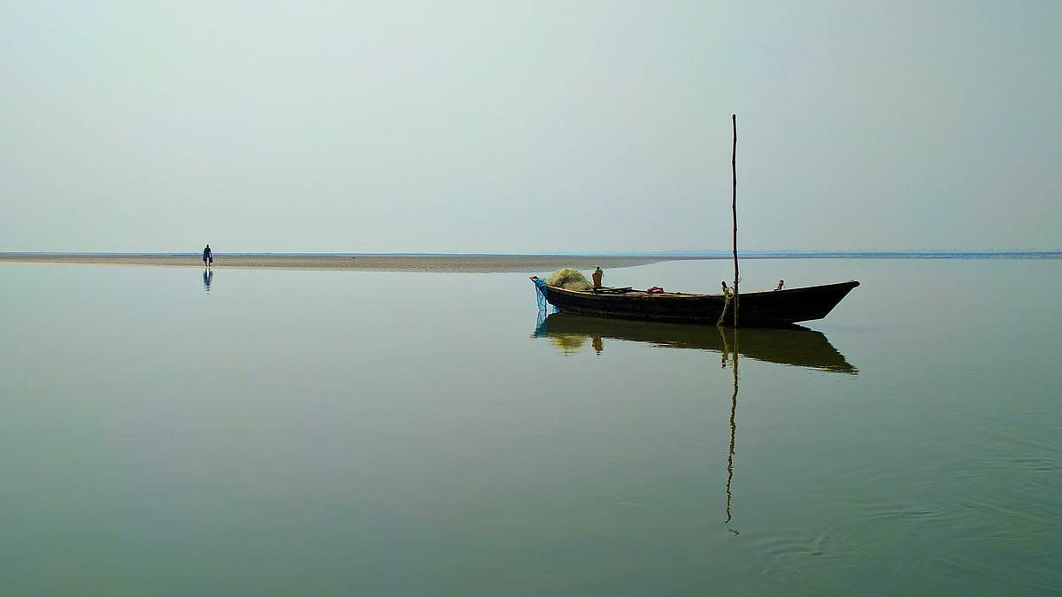 UP Elections 2017: A fisherman waits for his catch on the banks of the calm Ghaghra river, while crossing river Ghaghra, between Sitapur and Bahraich, in Uttar Pradesh.