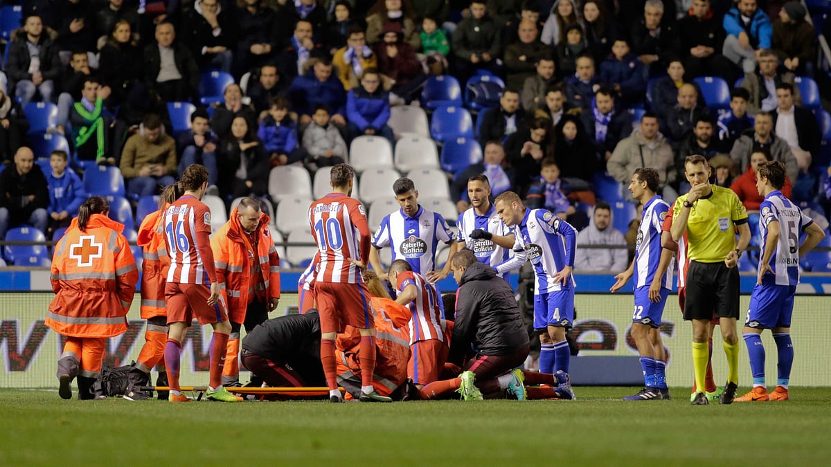 Paramedics and players gather around Atletico Madrid’s Fernando Torres as he lies injured on the ground. (Photo: Reuters)