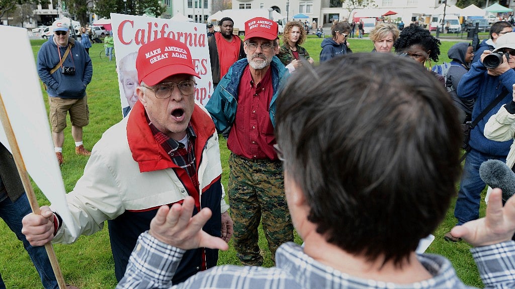 Trump supporter Jim Templeton, left, yells at an anti-Trump protester at a rally for President Donald Trump on Saturday. (Photo Courtesy: AP)