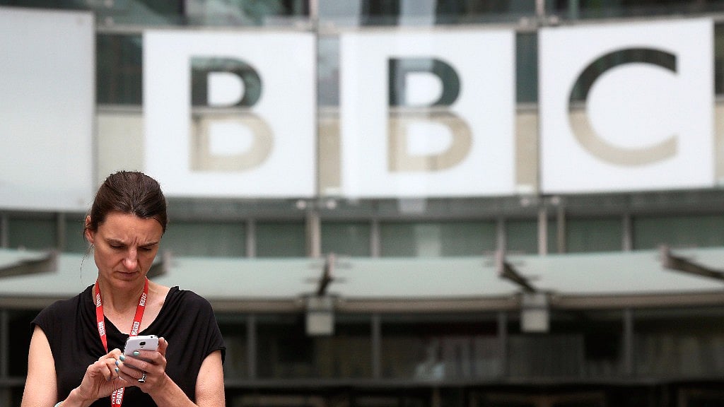 An employee stands outside Broadcasting House, the headquarters of the BBC, in London. Representational image. (Photo: Reuters)