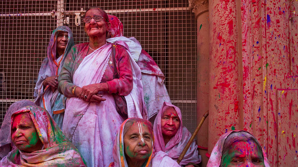 

Widows, who were once forbidden to participate, rest covered in colored powder during Holi festival at the Gopinath temple in Vrindavan. (Photo Courtesy: AP)