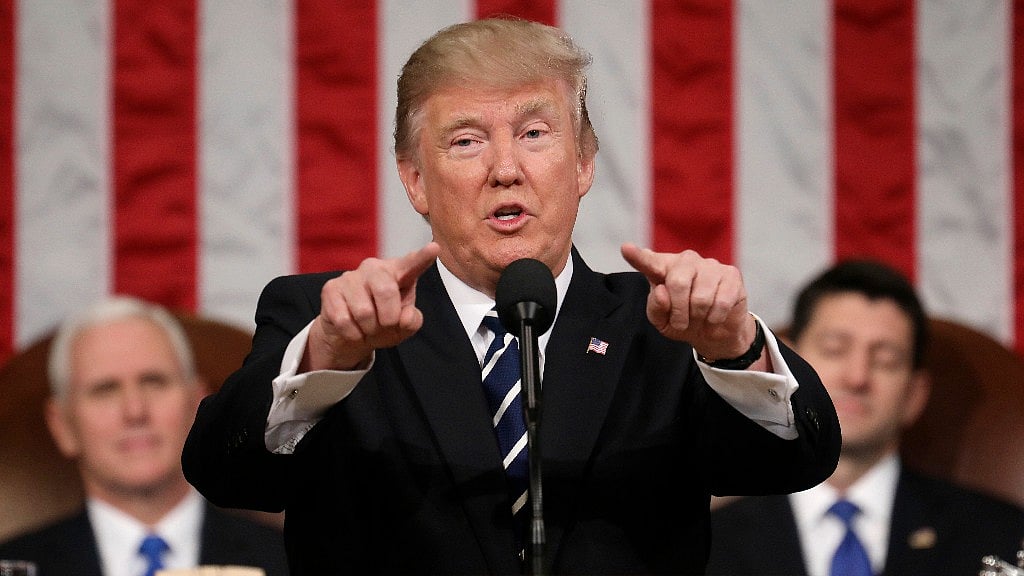 President Donald Trump, flanked by Vice President Mike Pence and House Speaker Paul Ryan, gestures on Capitol Hill in Washington. (Photo: AP)