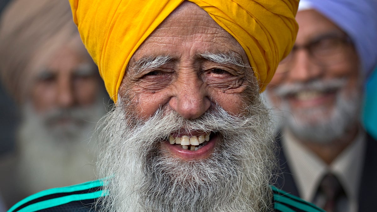 Fauja Singh is all smiles before taking part in the inaugural Surrey World Music Marathon in 2012. (Photo: Reuters)