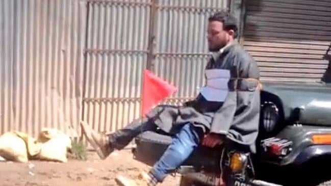 A screengrab of the youth tied to an army vehicle. (Photo: Screengrab) 
