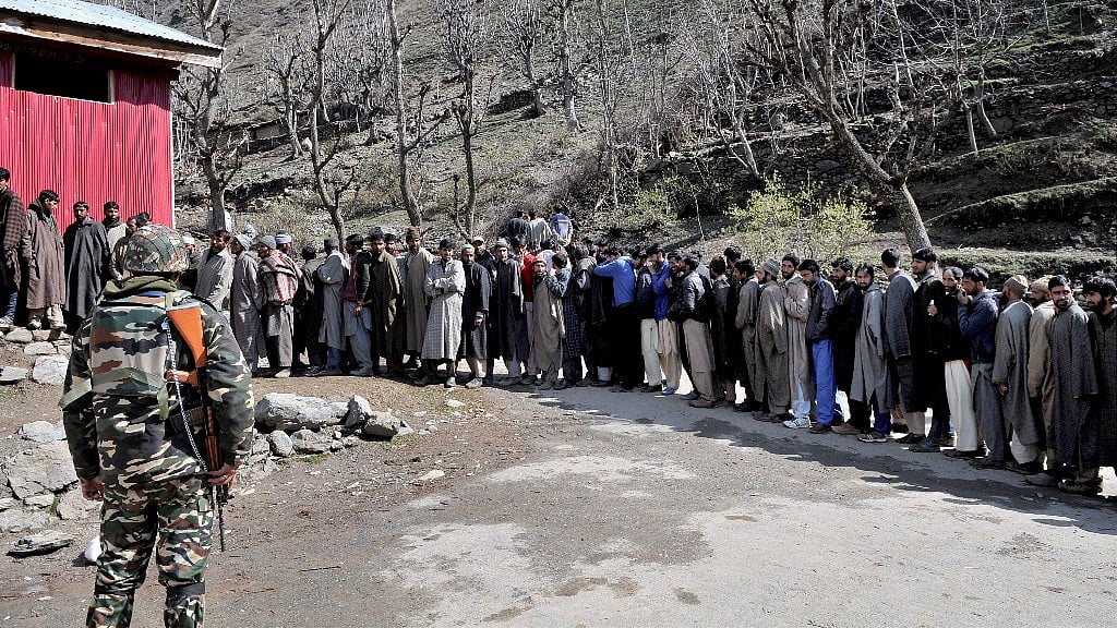 Voters in a long queue to cast their votes during Lok Sabha elections, at a polling booth in Srinagar on Sunday. (Photo Courtesy: PTI)