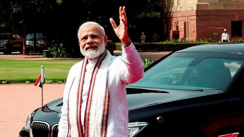Prime Minister Narendra Modi waves to media. 