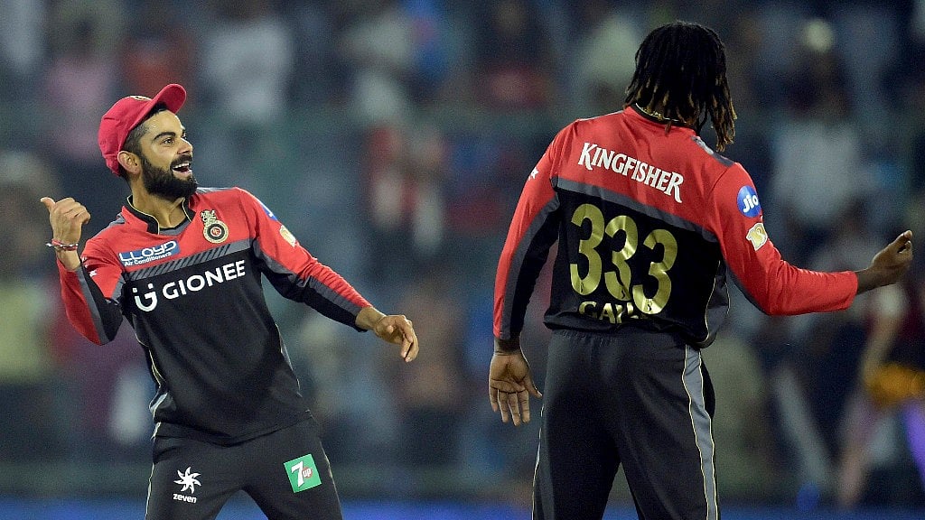 Royal Challengers Bangalore captain Virat Kolhli with teammates Chris Gayle celebrates their win over Delhi Daredevils during an IPL match in New Delhi on Sunday. (Photo: PTI)