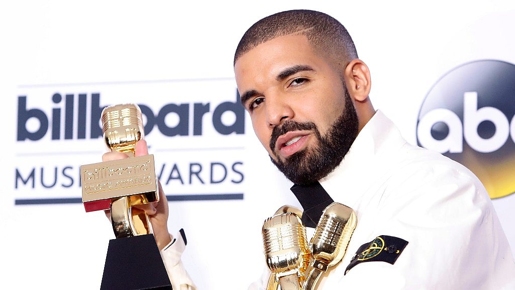 Drake shows off his awards. 