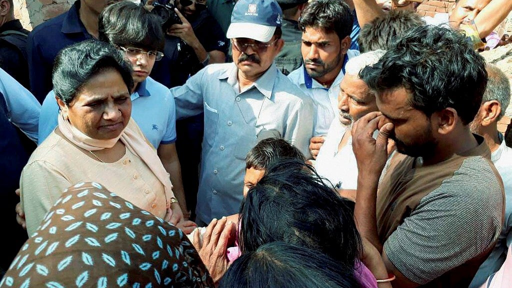 BSP chief Mayawati interacts with violence-hit people in Sabbeerpur village in Saharanpur district on Tuesday. (Photo: PTI)