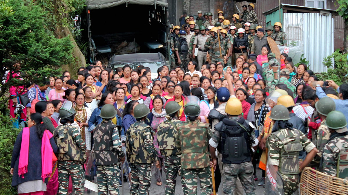 Security forces personnel trying to control woman Gorkha Janamukti Morcha (GJM) supporters during a protest at their office in Darjeeling on Thursday. (Photo: PTI )
