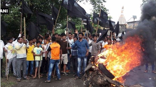 The agitated farmers also blocked a busy road in the area by throwing burning tyres on it. (Photo: ANI)