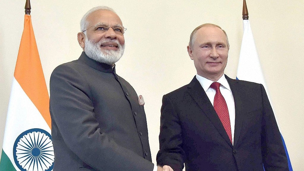 Prime Minister Narendra Modi shakes hands with Russian President Vladimir Putin, at the 18th India Russia Annual Summit. 