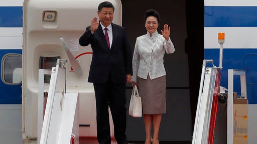 Chinese President Xi Jinping and his wife Peng Liyuan wave after arriving at Hong Kong’s airport on 29 June, 2017.