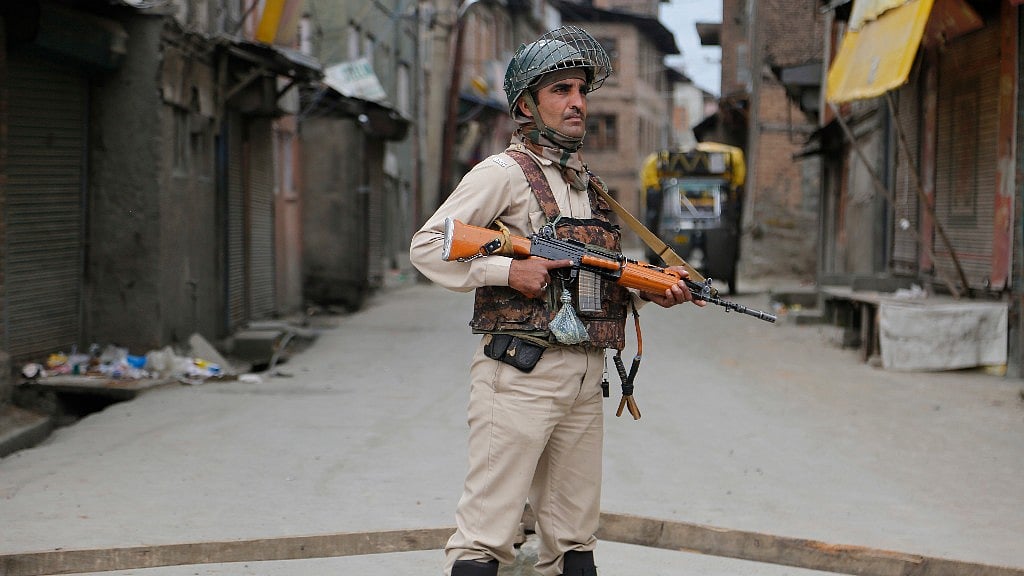 An Indian paramilitary soldier guards at a temporary checkpoint during restrictions in Srinagar. Image used for representational purpose. (Photo: AP)