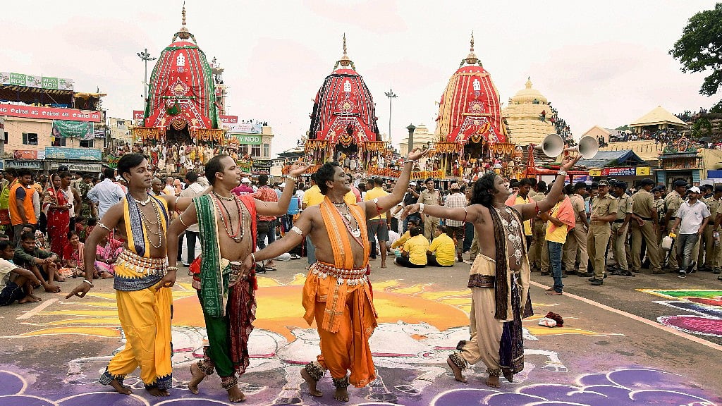 Odissi dancers perform in front of the three chariots during the inauguration of the annual Lord Jagannath Rathyatra festival in Puri.