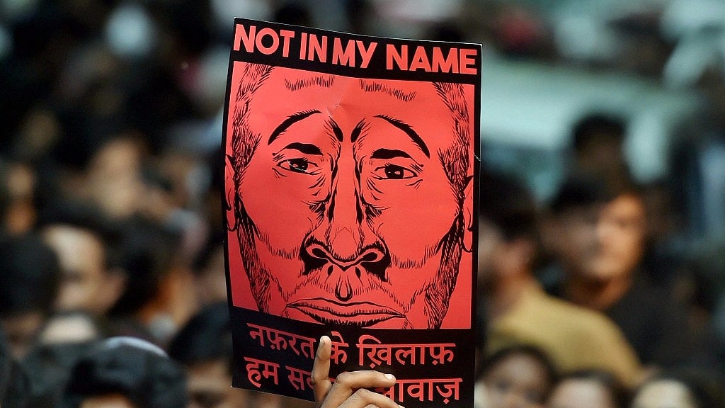 A participant shows a placard during a “Not in My Name” protest in New Delhi.