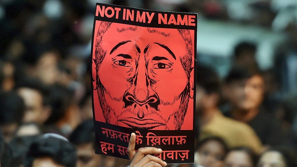 A protester holds up a “Not in My Name” placard at Jantar Mantar in New Delhi.