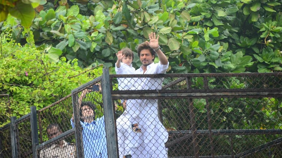 Shah Rukh Khan with son AbRam waving to fans outside his home in Bandra.