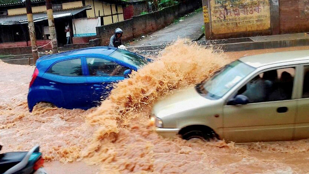 Guwahati: Vehicles wade through a flooded street after heavy shower in Guwahati on Tuesday. (Photo: PTI)