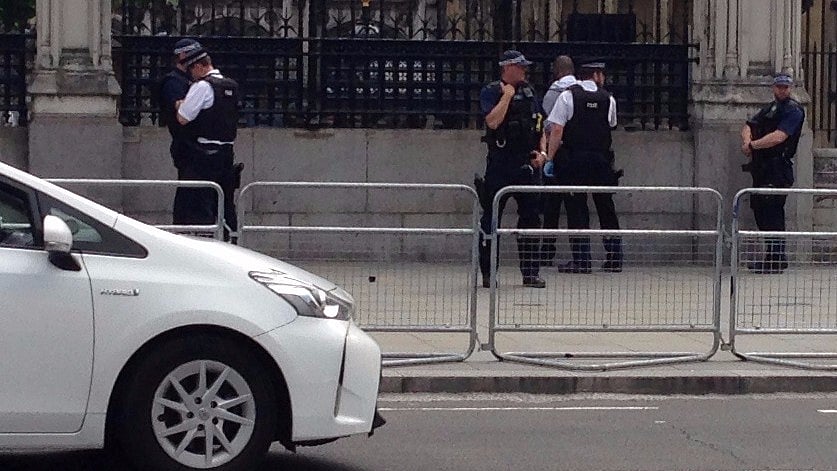 Police officers detain a man outside the Palace of Westminster, in central London. (Photo: Reuters)