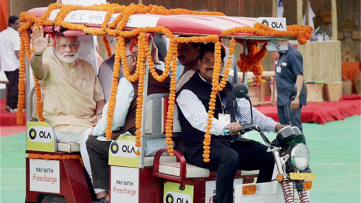 PM Narendra Modi in Ola’s e-rickshaw. 