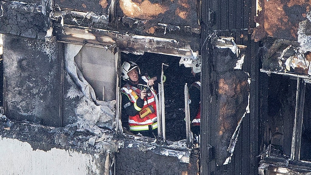 A firefighter checks damage after a fire engulfed the Grenfell Tower in London. (Photo: AP)