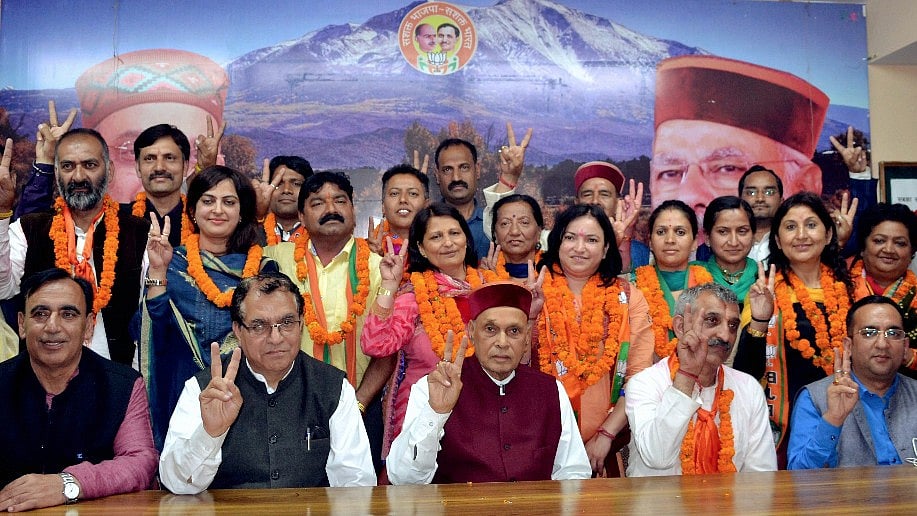 The BJP’s winning councilors in the Municipal corporation election with former chief minister Prem Kumar Dhumal in Shimla on Saturday. (Photo: PTI)