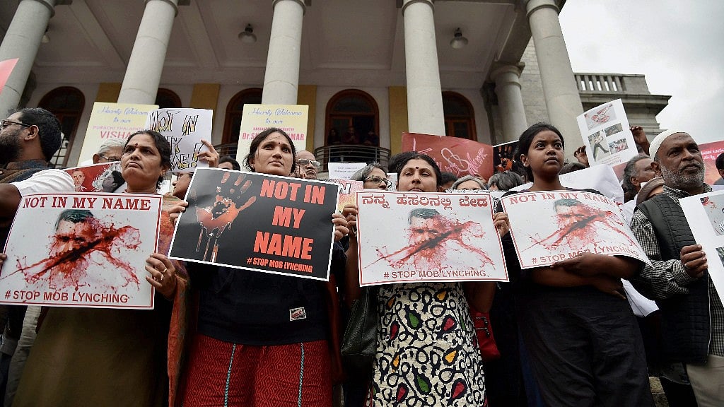 Citizens hold placards during a silent protest ‘Not in My Name’ in Bengaluru. (Photo: <b>The Quint</b>)