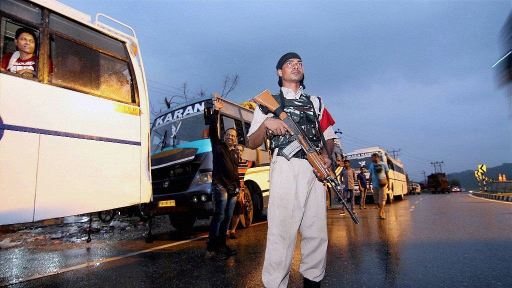 A paramilitary security personnel keeping vigil on the outskirts of Jammu as a convoy of Amarnath pilgrims leave for Kashmir. 