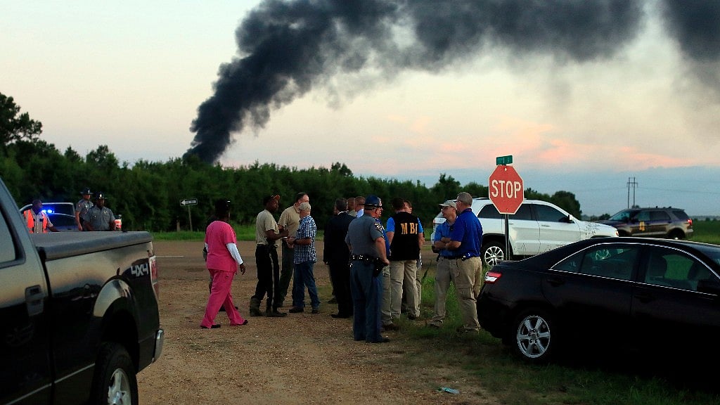 Emergency officials respond to the site of a military plane crash in Mississippi on Monday.