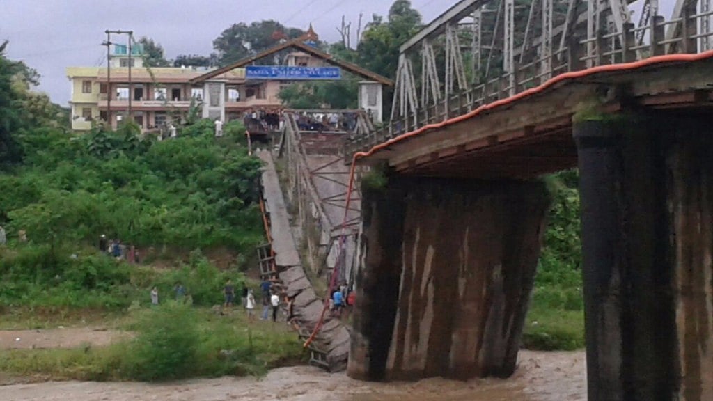 A portion of the bridge remains submerged under water. 