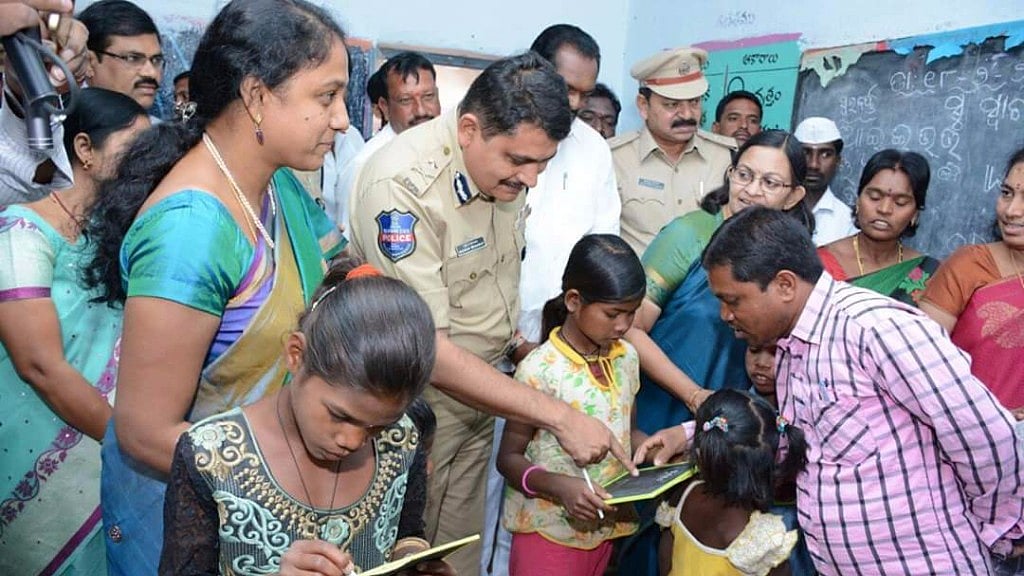 Police officer Mahesh Muralidhar Bhagwat interacting with children rescued from a brick kiln at Chikati Mamidi village of Telangana in January 2016.