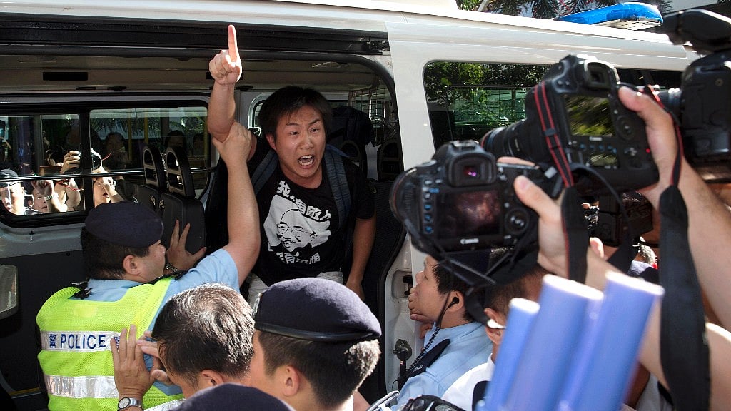 A pro-democracy activist being taken away by the police during protests in Hong Kong on Saturday, 1 July.