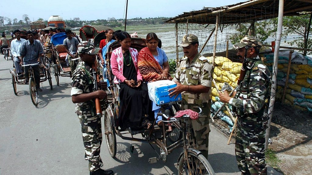 Indian paramilitary soldiers check the belongings of a Nepalese family at the Indo-Nepal border. Image used for representational purpose.