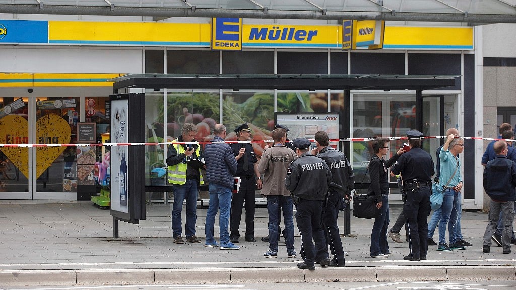 Police officers outside supermarket in Hamburg, Germany where the incident took place.