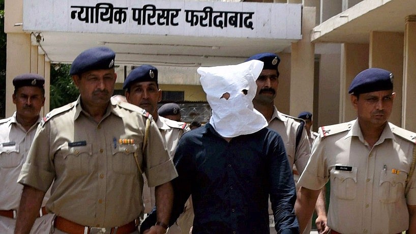 Police escort the prime accused in Junaid’s lynching case at a court in Faridabad on Sunday. (Photo: PTI)