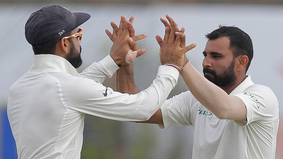 Mohammed Shami celebrates a wicket with Virat Kohli.
