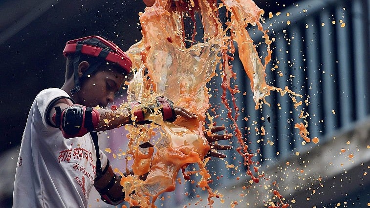 <div class="paragraphs"><p>A boy breaks a <em>dahi handi</em> during Janmashtami celebrations in Mumbai. Image for representational purposes.</p></div>