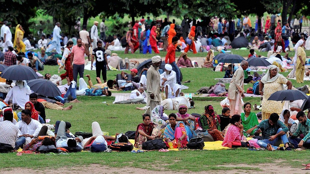 Followers of Dera Sacha Sauda chief Gurmit Ram Rahim gather at a park in Panchkula on Wednesday, ahead of the court judgement in a sexual exploitation case against him.