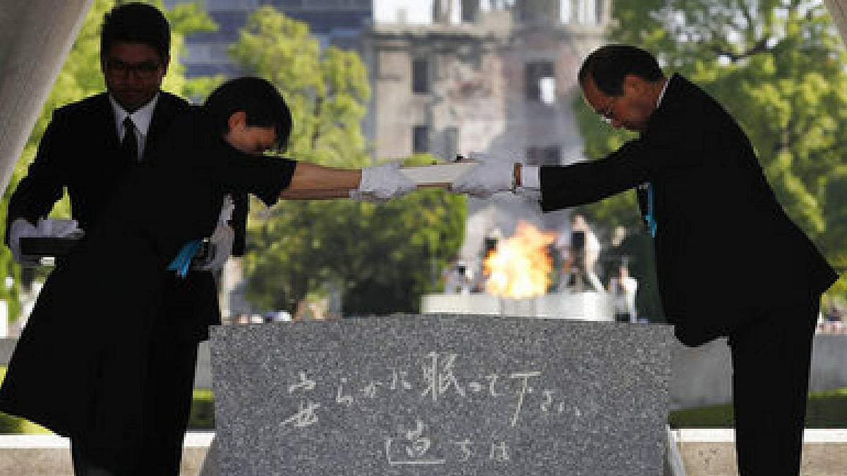Hiroshima Mayor Kazumi Matsui, right, hands over the name list of newly-added people who died of the world’s first atomic bombing over the past year during a ceremony to mark the 72nd anniversary of the 1945 bombing. 