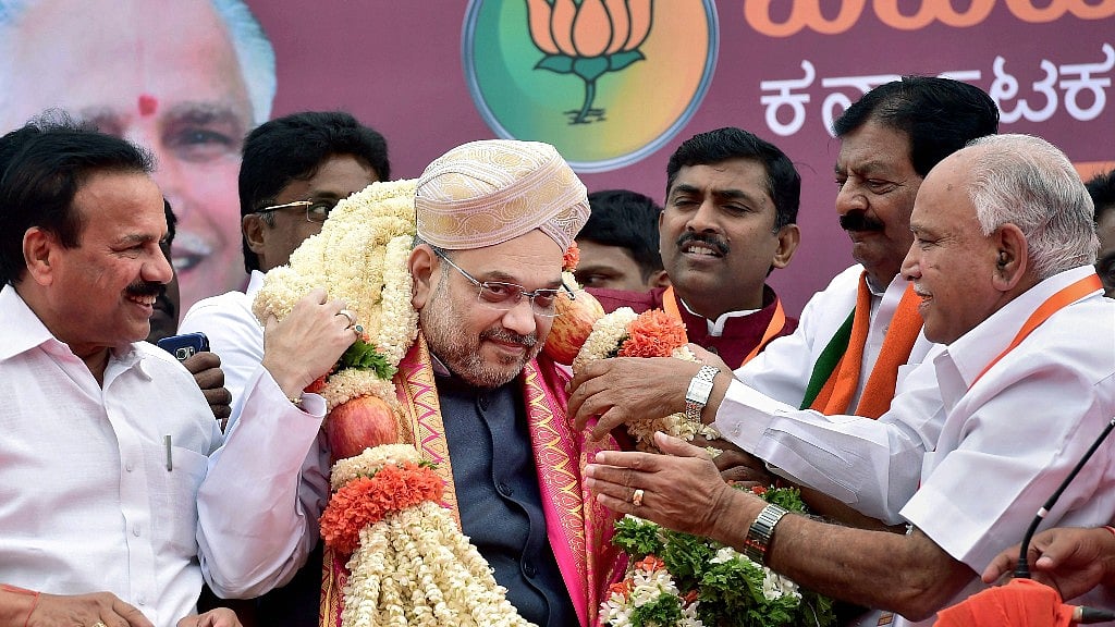 BJP president Amit Shah being welcomed by party’s state unit president B S Yeduyurappa upon his arrival on a three-day visit to Karnataka as part of his 110-day nationwide tour in Bengaluru.