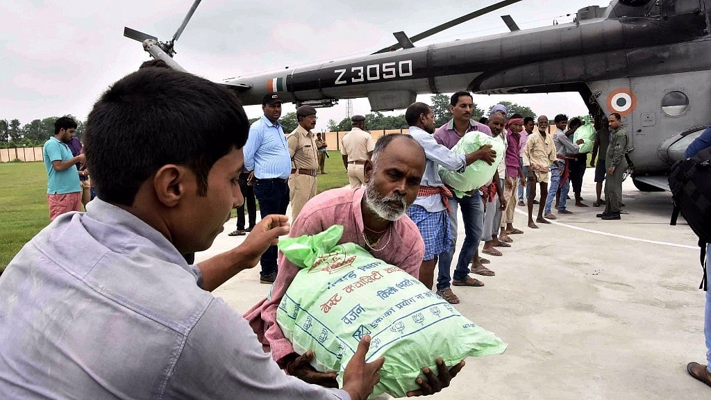 Food being loaded in an Indian Air Force (IAF) chopper to be transported to the victims of flood in Bettiah, Bihar on Aug 18, 2017. 