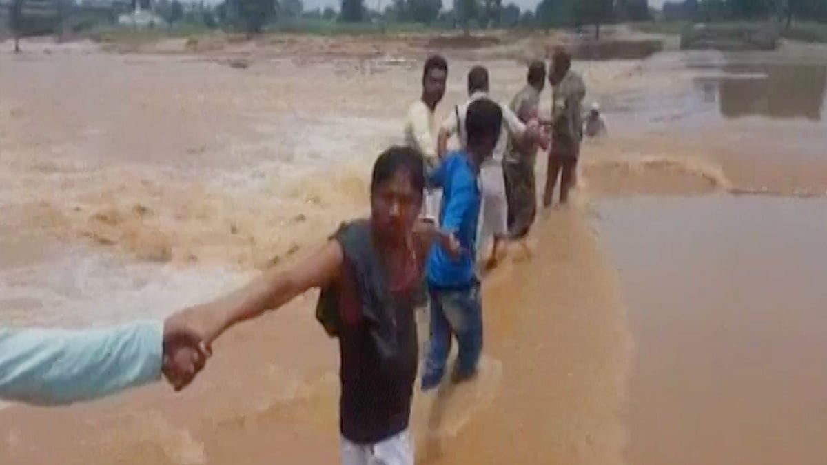 Locals and policemen form human chain.