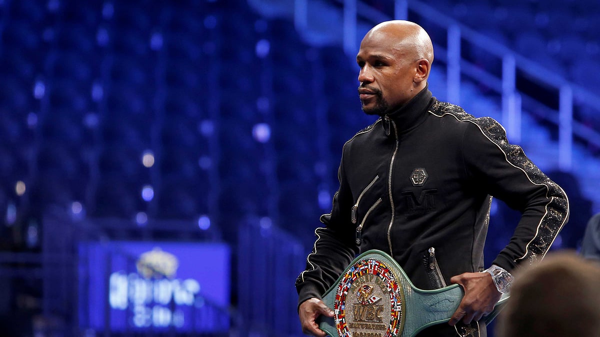 Undefeated boxer Floyd Mayweather Jr. of the U.S. poses with the WBC “Money Belt” during post-fight news conference at T-Mobile Arena in Las Vegas