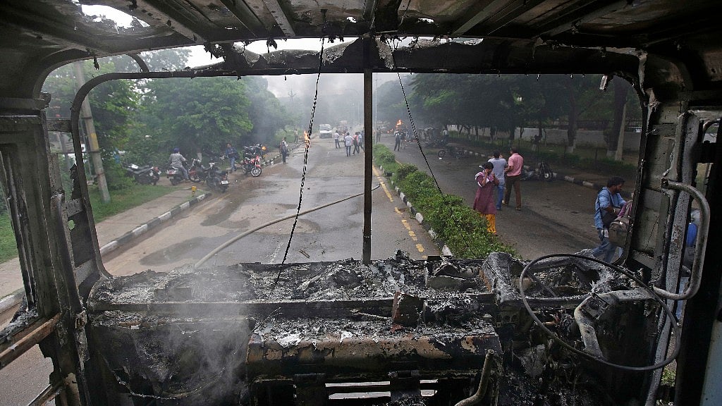 A fire brigade truck burnt by Dera Sacha Sauda members lies near the CBI court in Panchkula.