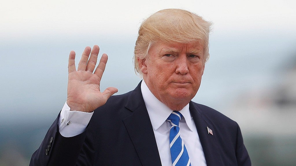 US President Donald Trump waves as he walks across the tarmac to board Air Force One at Hagerstown Regional Airport