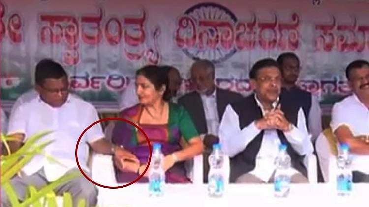Congress leader Ramesh is seen smiling as Veena Achaiah looks visibly uncomfortable in the footage.